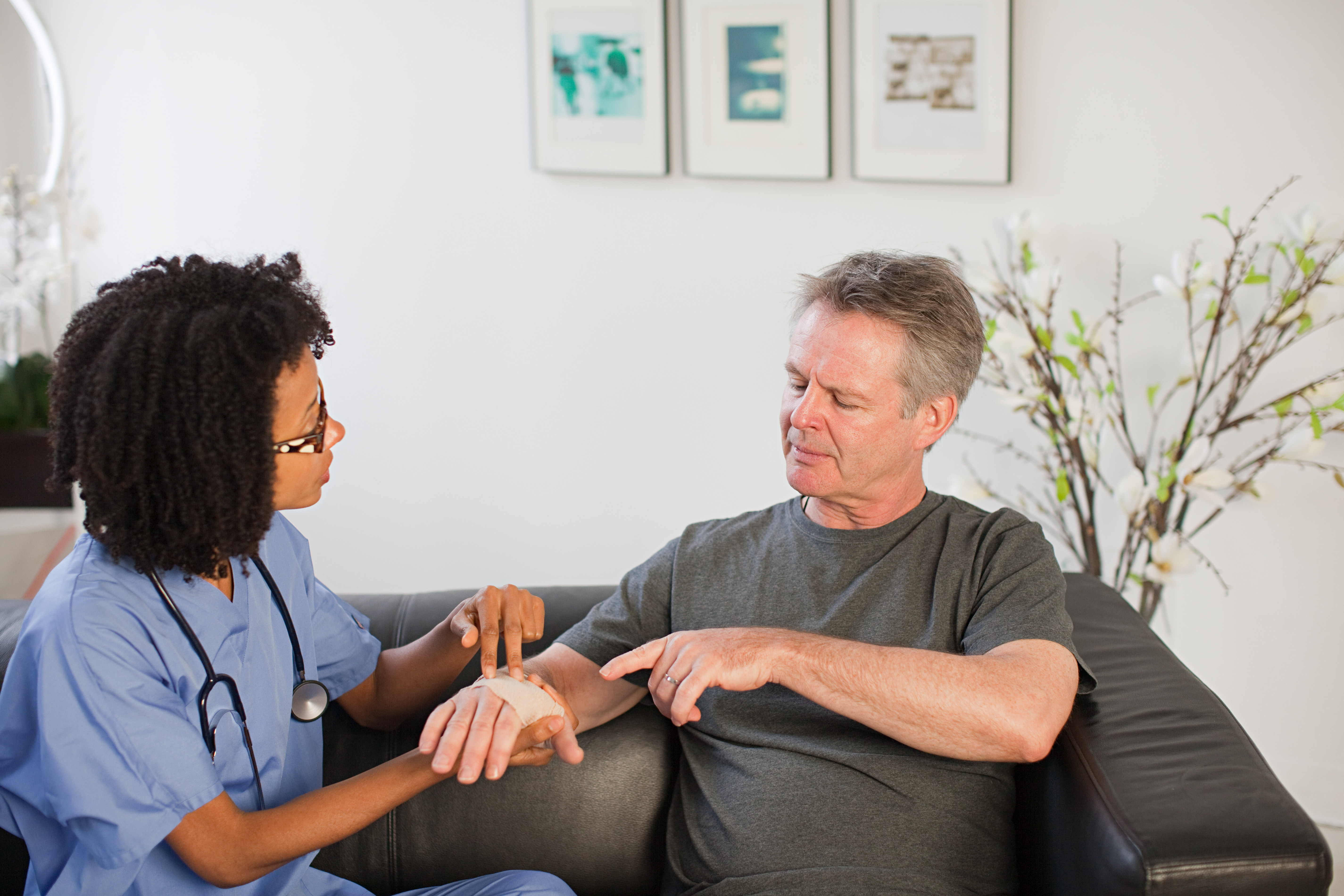 Nurse visiting man with wrist injury