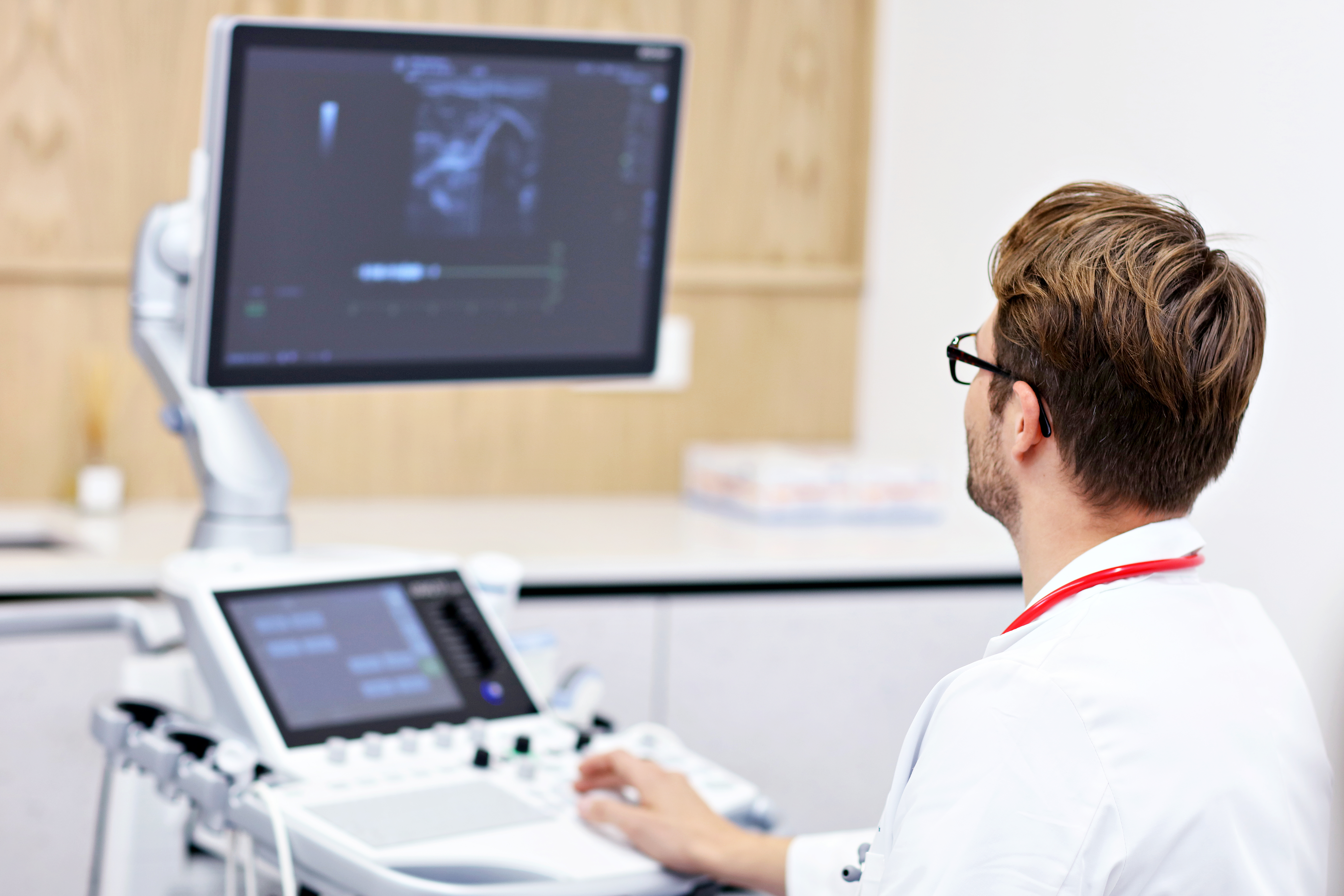 Doctor using ultrasound machine