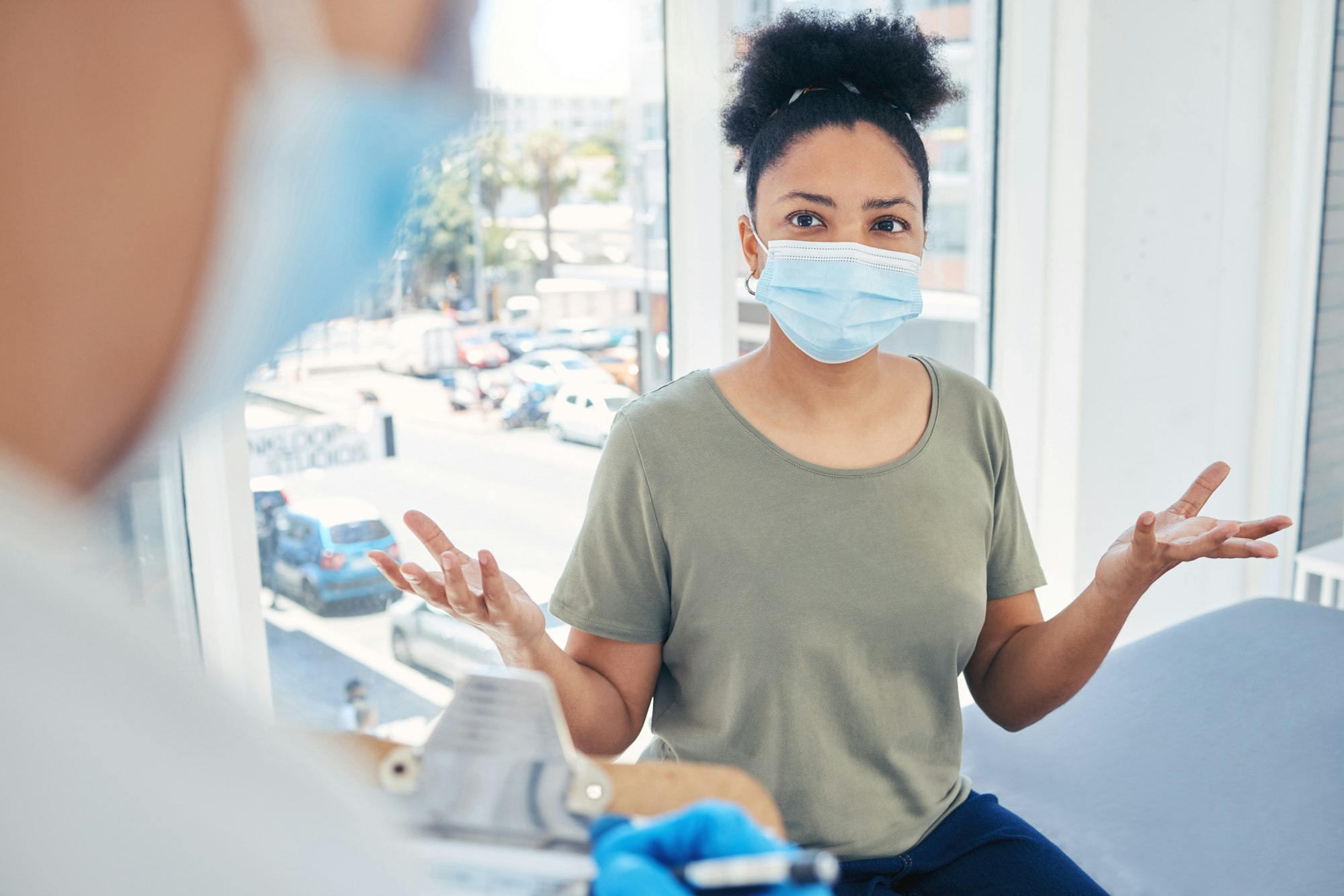 Covid, healthcare and patient in a hospital with a doctor looking frustrated at a delay during a me