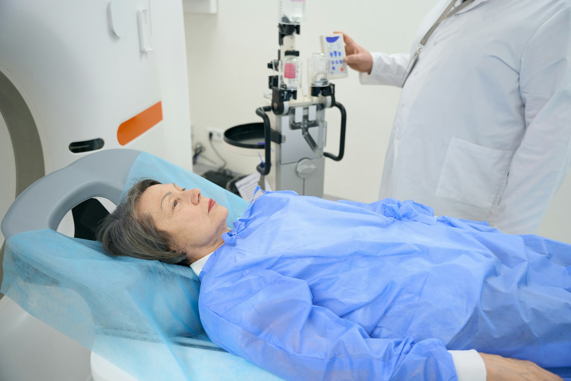 Doctor conducts CT scan of the brain of elderly lady