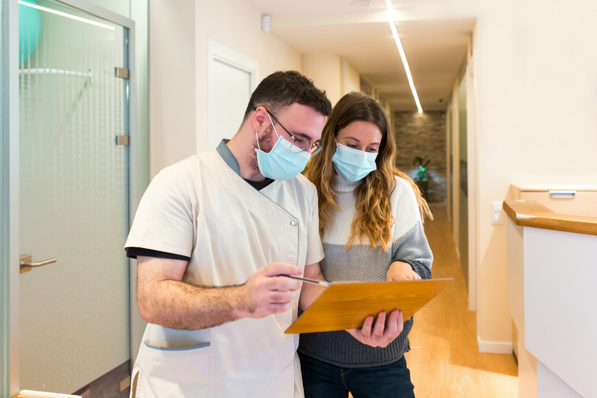 Nurse explaining notes to female patient in health center